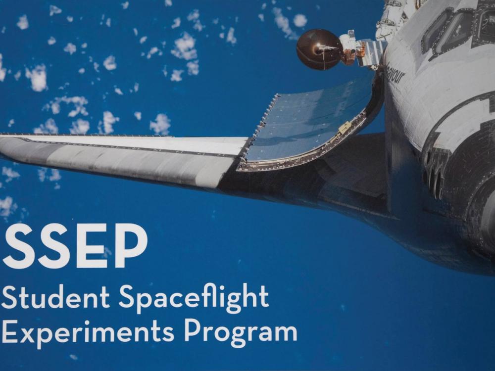 Graphic with a space shuttle in flight in the sky with clouds. Below the wing of the space shuttle the acronym "SSEP" is mentioned above its meaning: "Student Spaceflight Experiments Program".