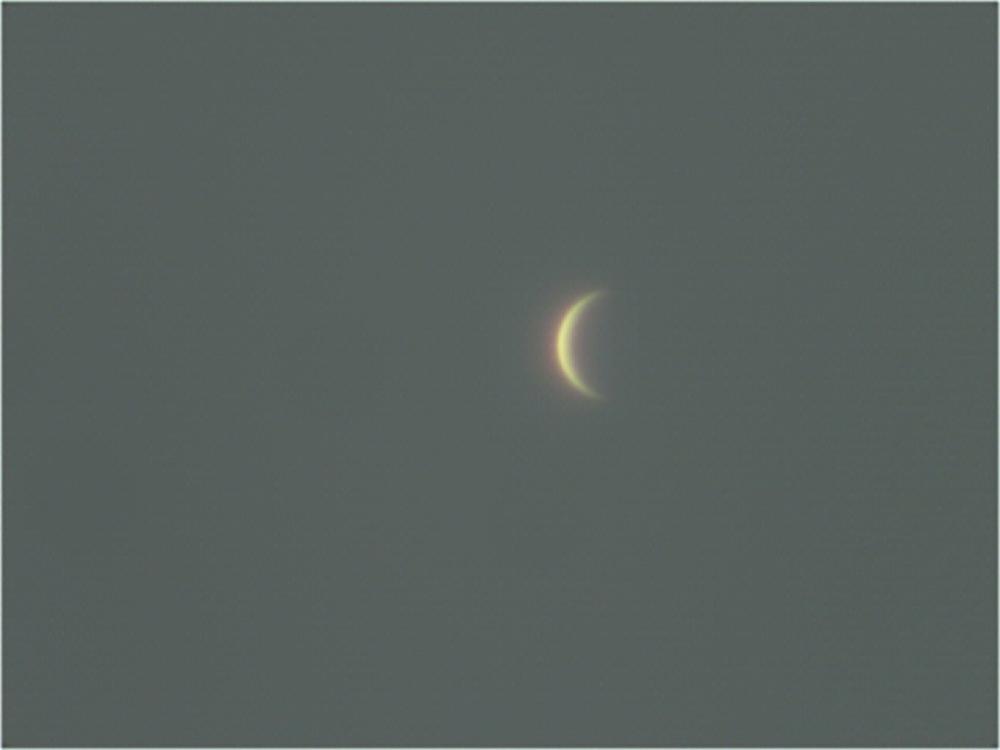 View of Venus as a waxing crescent in the sky.