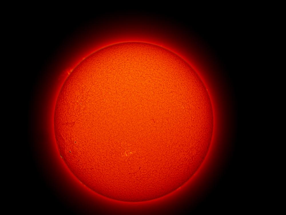 Disk view of the sun with a large prominence of floating gases on the upper right quadrant of the disk and a phage highlighted in yellow in the bottom center half.