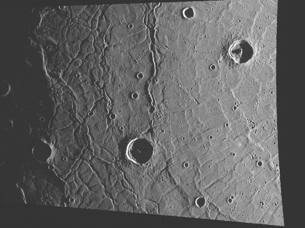 A view of topography on Mercury, featuring a basin on the left side and another set of trophs on the right side.