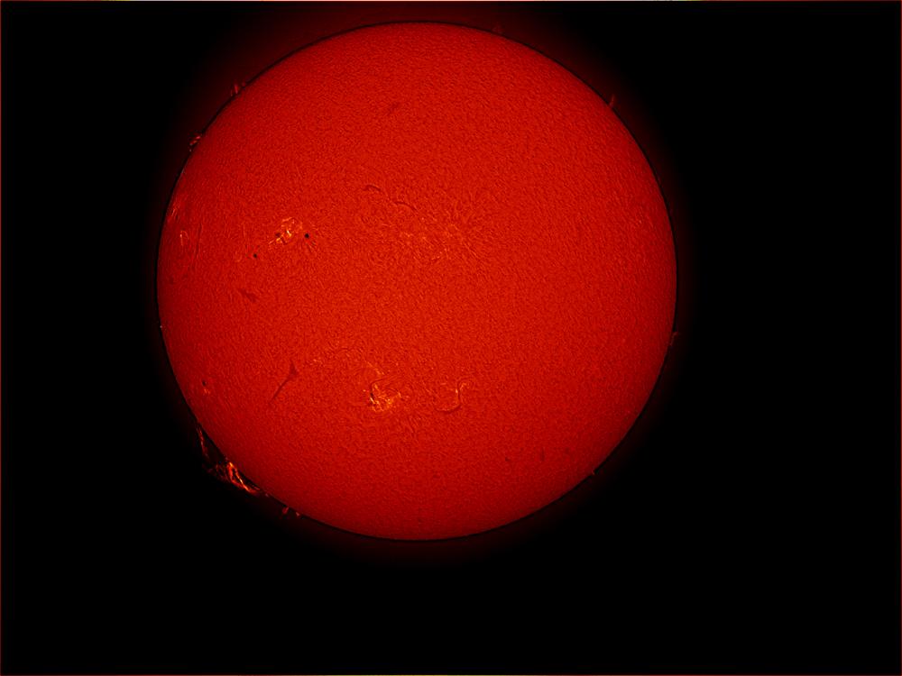 Disk view of the Sun featuring a prominence of floating gas above the lower half of the Sun. Phages are indicated by lighter colors and are visible mostly on the left half.