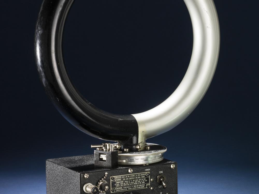 An circular antenna attached to a small rectangular box with various dials.