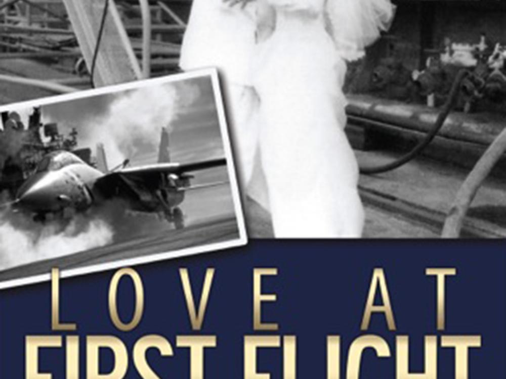 Cover for a book titled "Love at First Flight" in gold-colored text. Above the title is two images: One of an aircraft, and the other of two people, one wearing a Naval uniform and the other wearing a wedding dress, kissing each other.