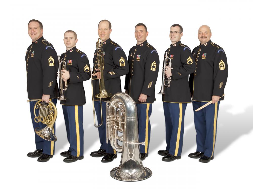 A group of six people holding various brass instruments.