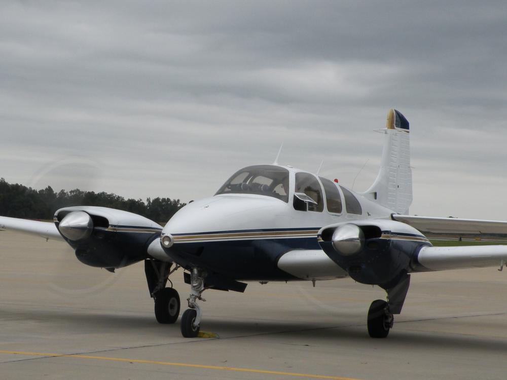 Front view of white and dark blue monoplane with twin engines.