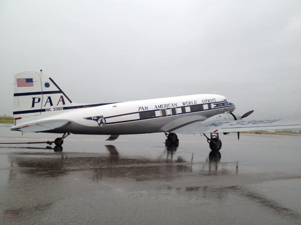 Side view of white and black commercial aircraft with two engines and Pan-American World Airways livery.