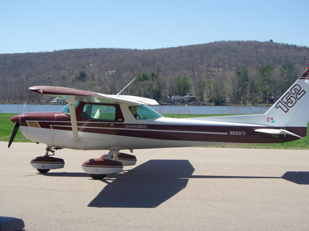 Red and white monoplane with single engine and fixed landing gear.