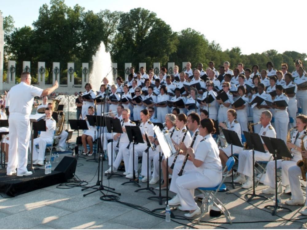 United States Public Health Service Music Ensemble, a large group of musicians, performs in a concert.