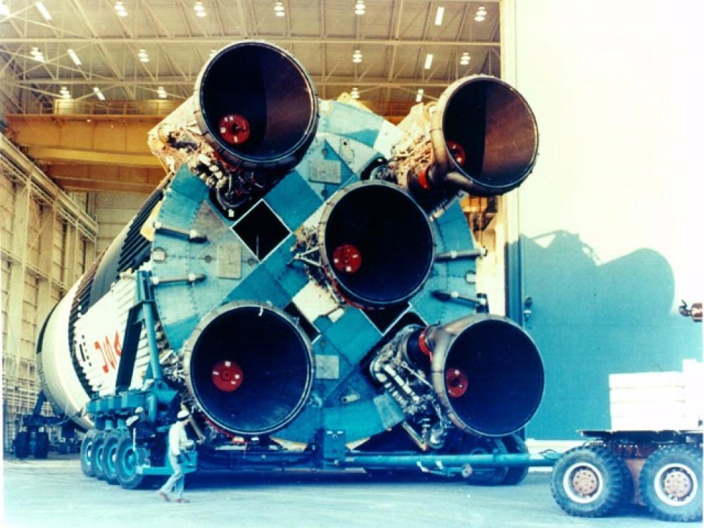 Bottom-facing view of a Saturn V rocket, focusing on five large engines.