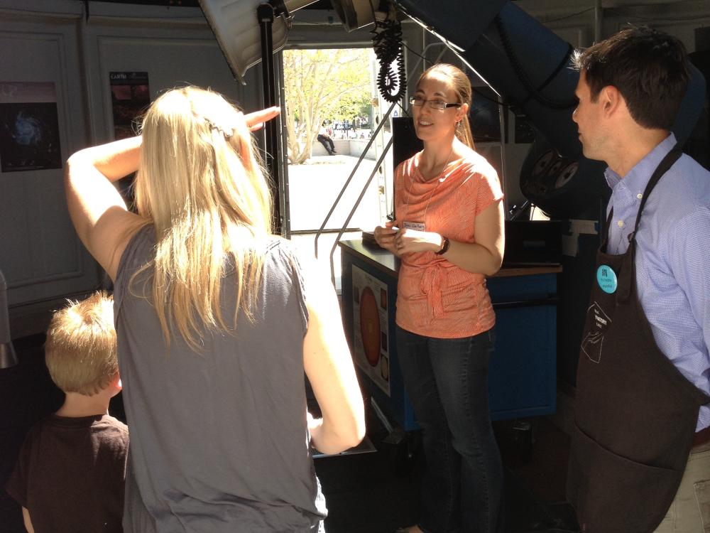 Museum visitors speak with a museum astronomy expert inside the Museum's observatory.