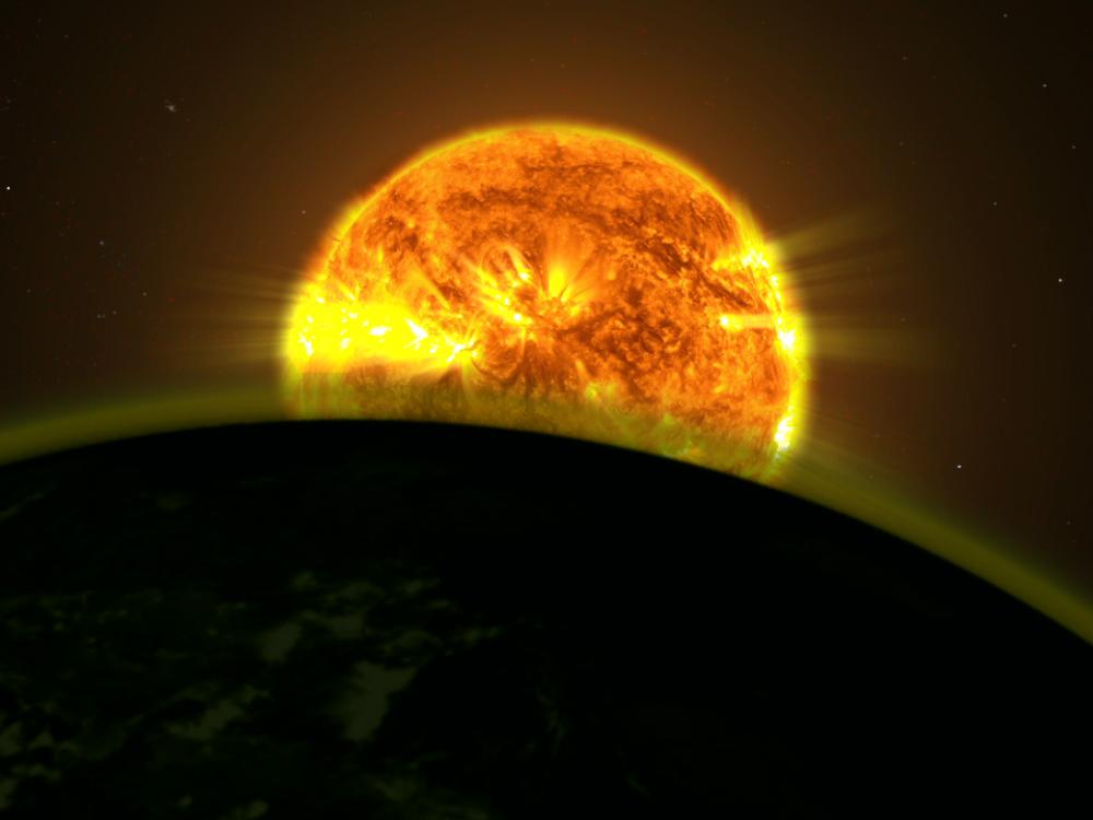 An illustration of the light of a star illuminating a planet with a hazy appearance.