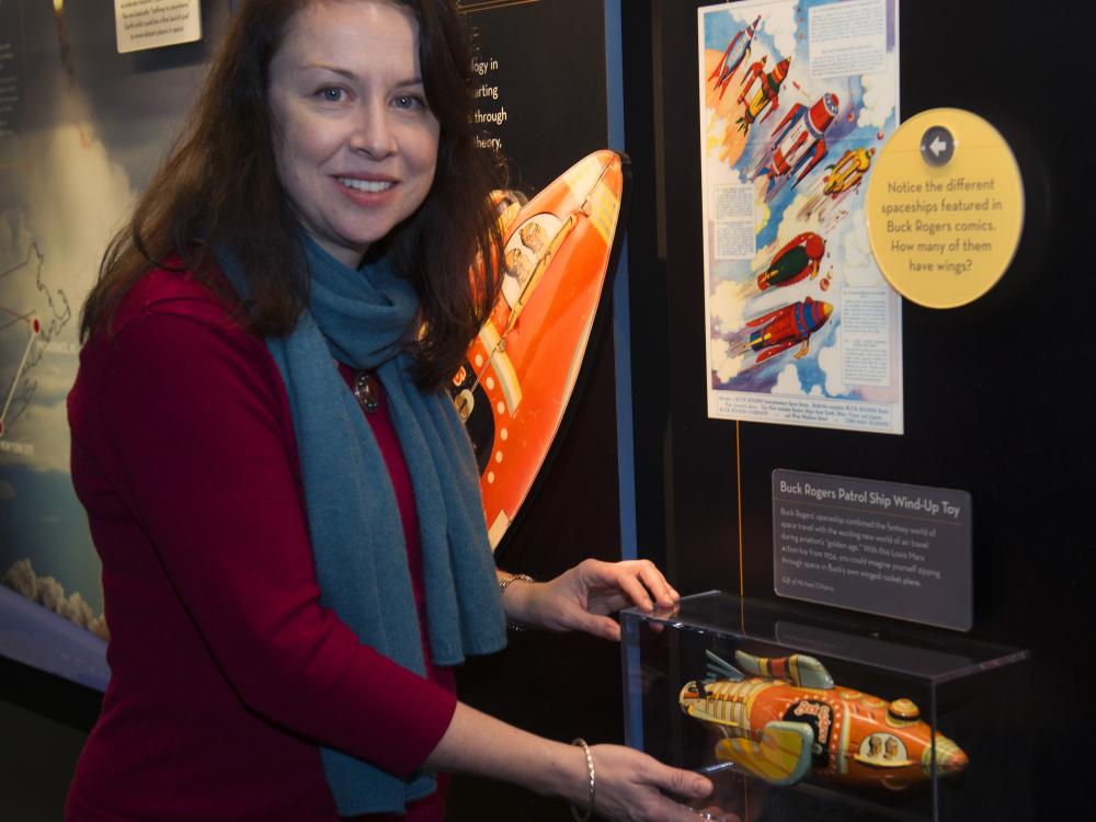 Margaret Weitekamp, the Museum's Curator of Space History, stands in front of an exhibit about space.