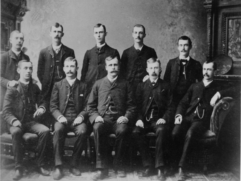 A group of ten white men known collectively as the 'Ten Dayton Boys'. Wilbur Wright was a member of this group, alongside his two older brothers, Reuchlin and Lorin.