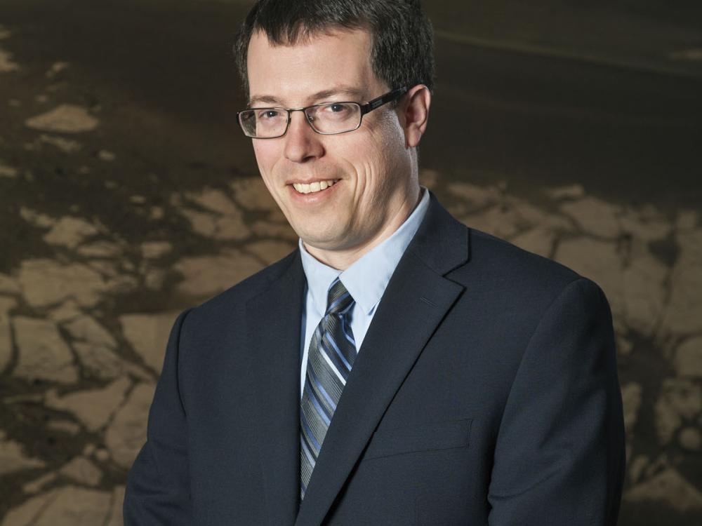 Dr. Ross Irwin, a white male geologist, poses for a portrait.