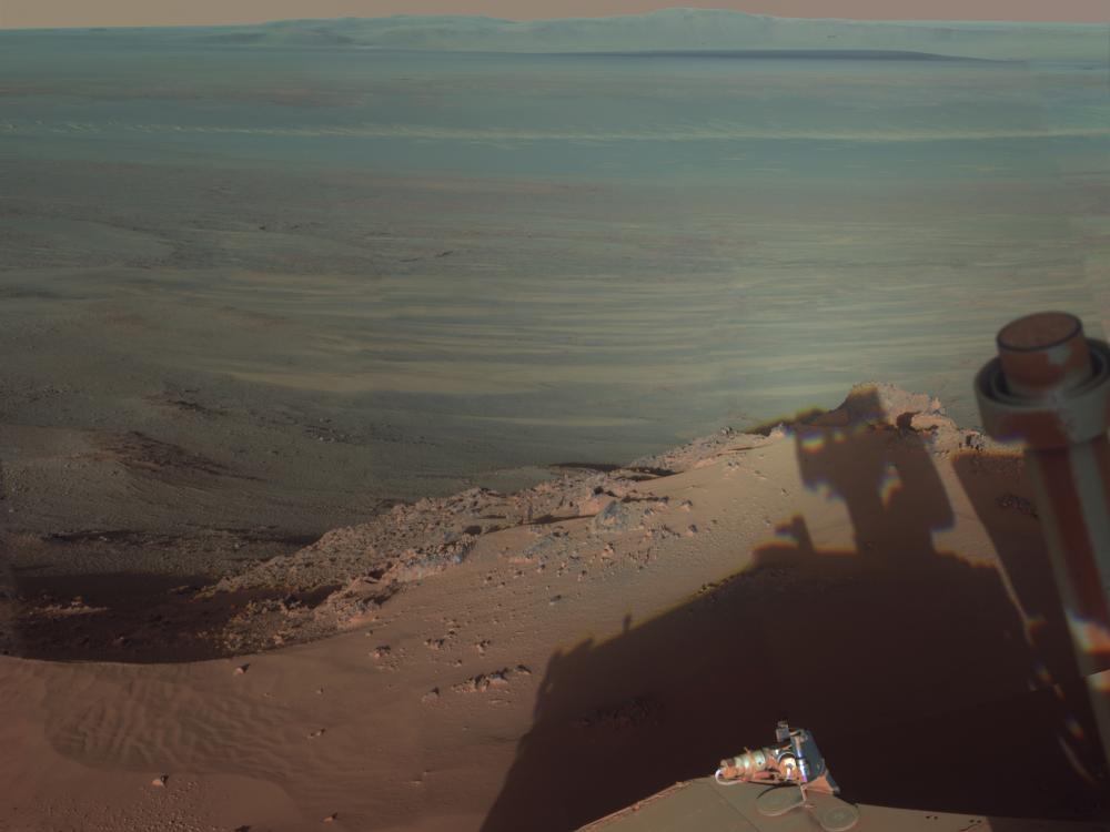 View of the interior and a far end section of a crater on Mars.