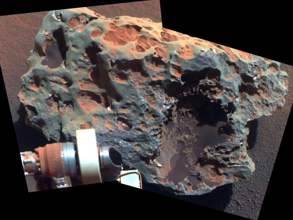 A large meteorite found and tested on Mars by Opportunity Rover, whose arm is visible in the view of the meteorite.