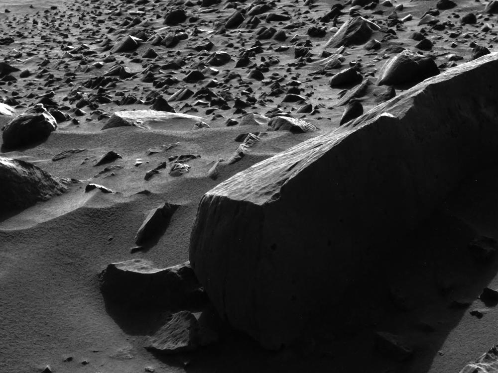 A rock on Mars with remarkably tall shadows.