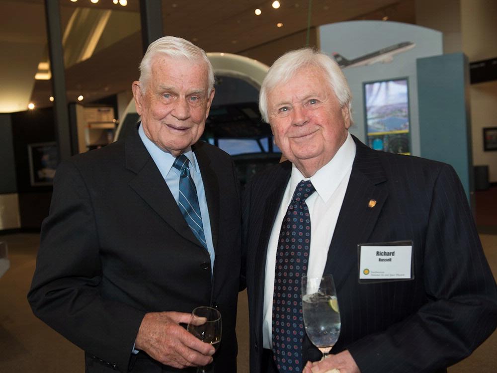 Richard Russell and Col. Bud Anderson, both white men, stand together at a lecture hosted by the museum.