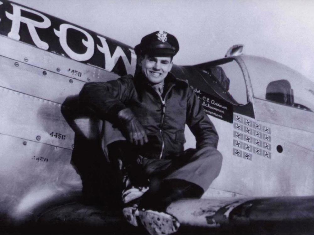 Col. Clarence E. "Bud" Anderson, USAF (Ret.), a white man, poses on the wing of an airplane.