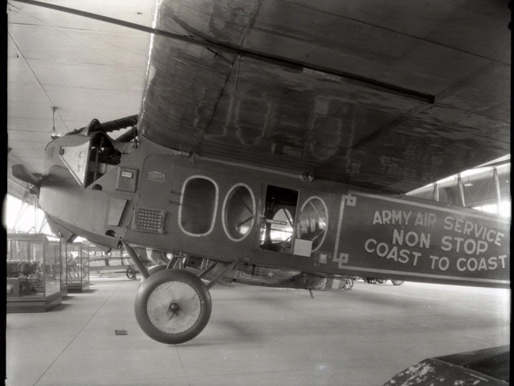 Side view of a monoplane with one engine on display in its prior home in the Smithsonian Castle.