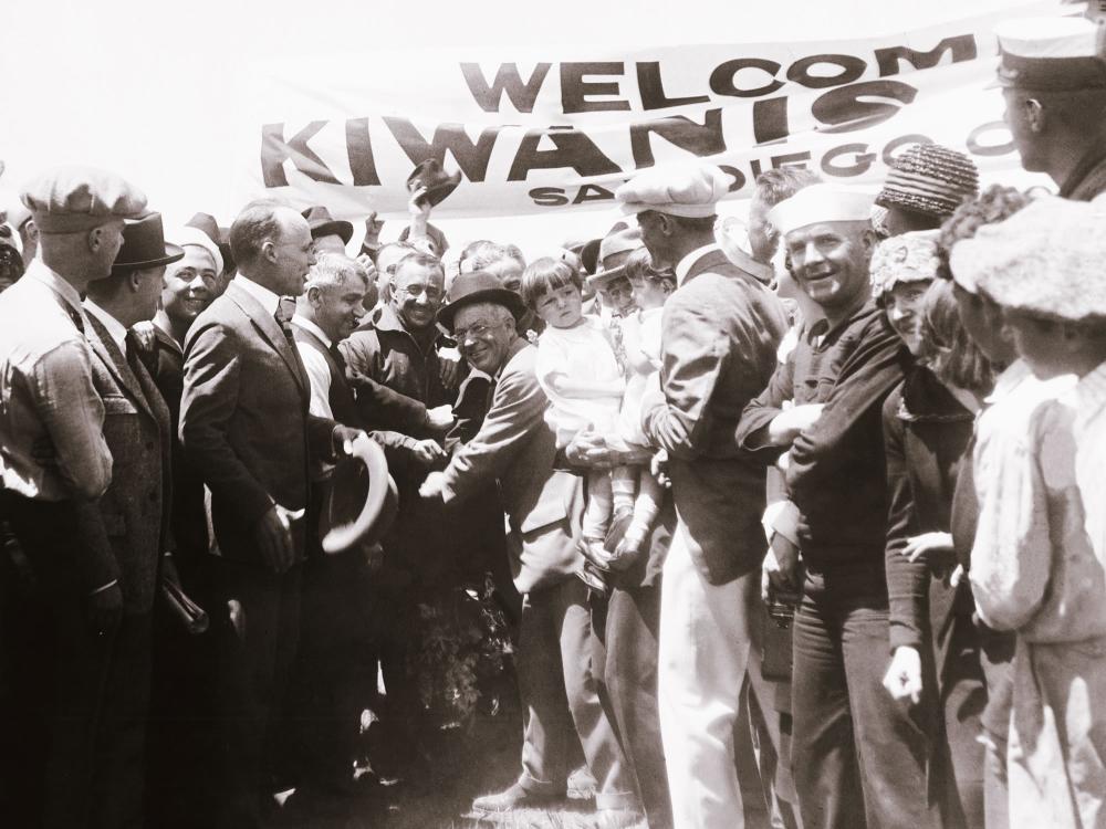 Pilots John Macready and Oakley Kelly, both male, receive a celebration after landing the T-2 plane.