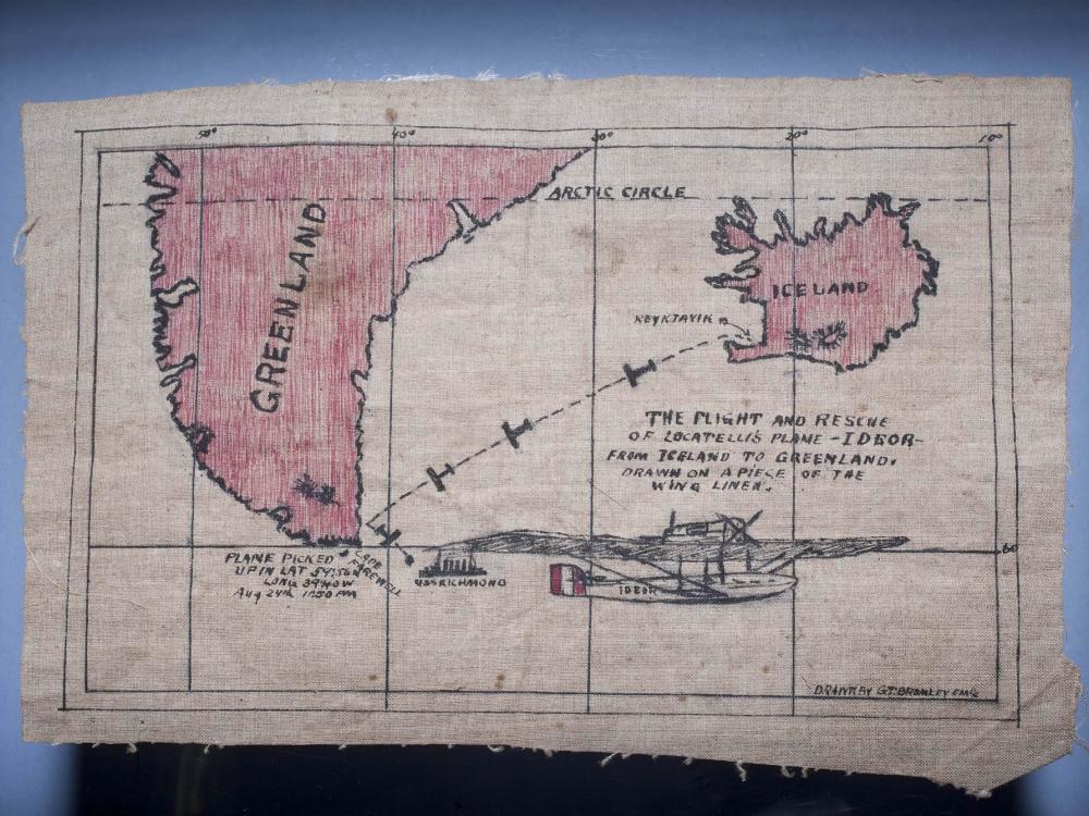 Fabric map souvenir describing a rescue following a failed world flight attempt. The map shows the rescue from near Greenland following travel from Iceland.