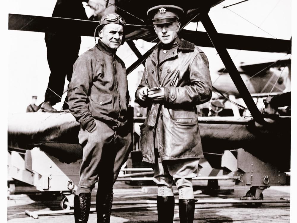 Jimmy Doolittle and Lt. Cyrus Bettis, both of whom are white male pilots, stand together under an aircraft.