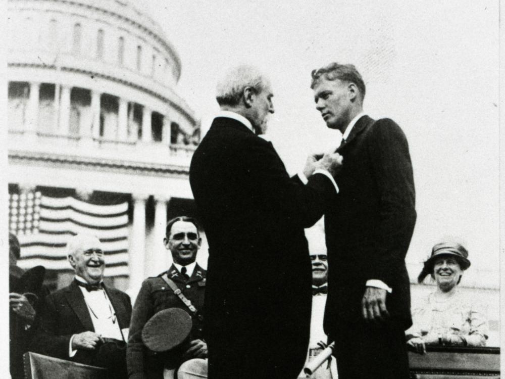 Charles Lindbergh receives a medal at a ceremony following his feat as the first to pilot alone during a nonstop transatlantic flight.