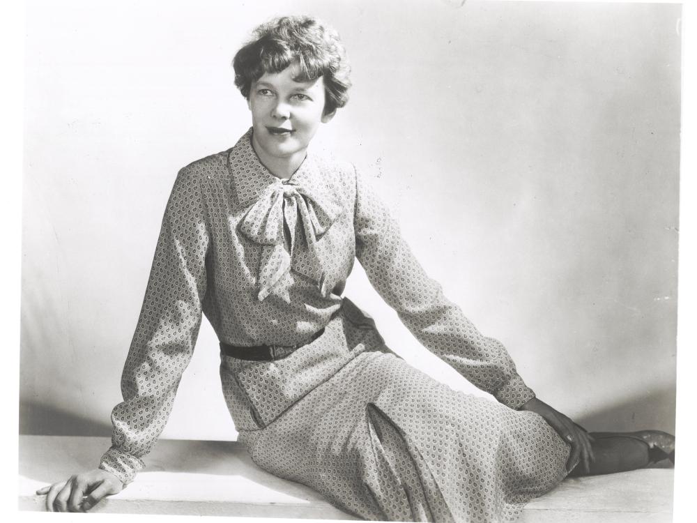 Amelia Earhart sits as she models clothing that she designed and made herself.