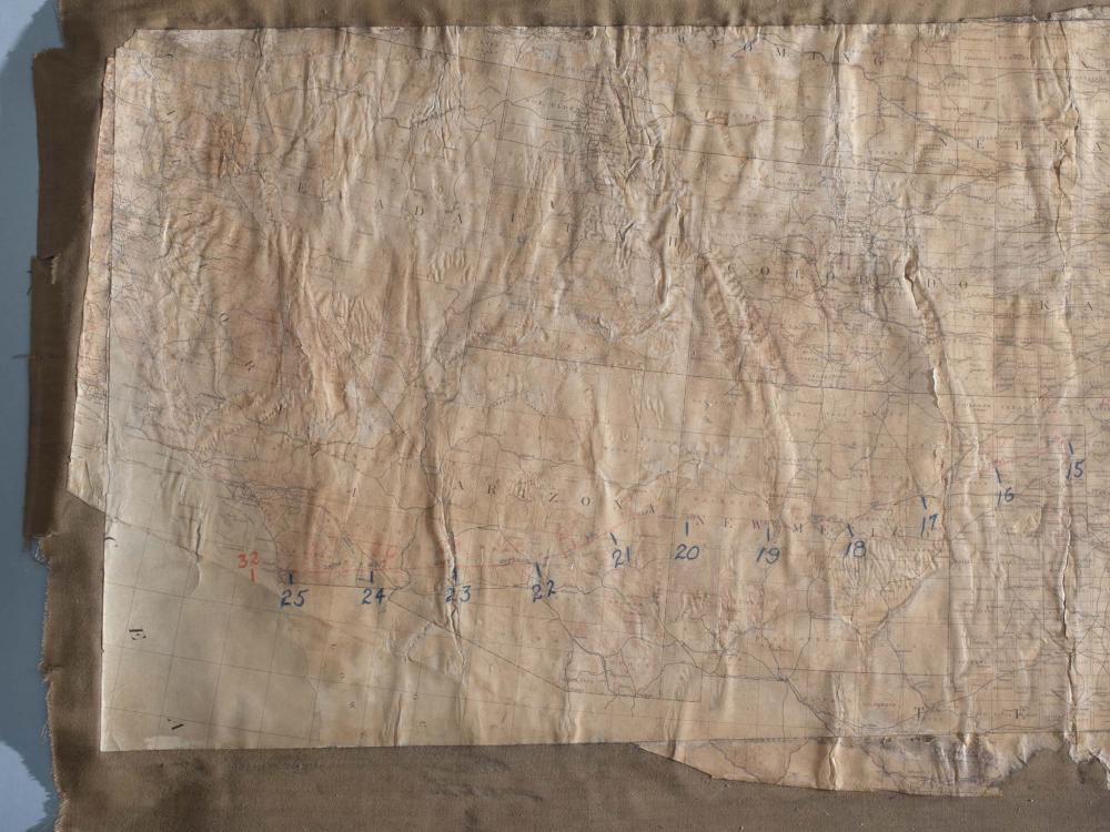 Close-up view of a faded map of United States with a focus on the western half of the country. The map was used to list stops on the first successful transcontinental flight.