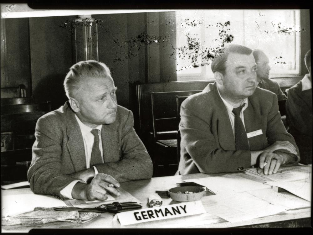 Eugen Sänger, a white male engineer, sits at a table near others.