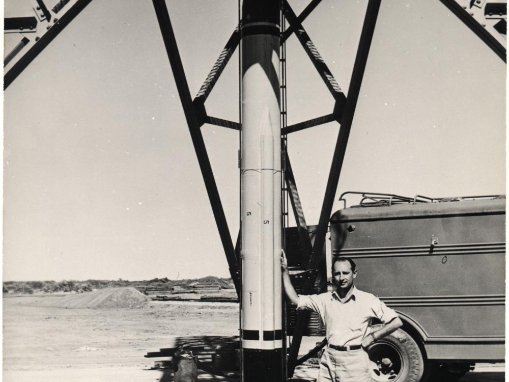 Frank Joseph Malina standing next to a rocket