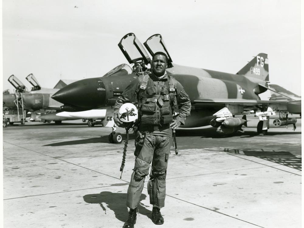 Daniel James Jr., an African-American male, poses formally in front of an aircraft.