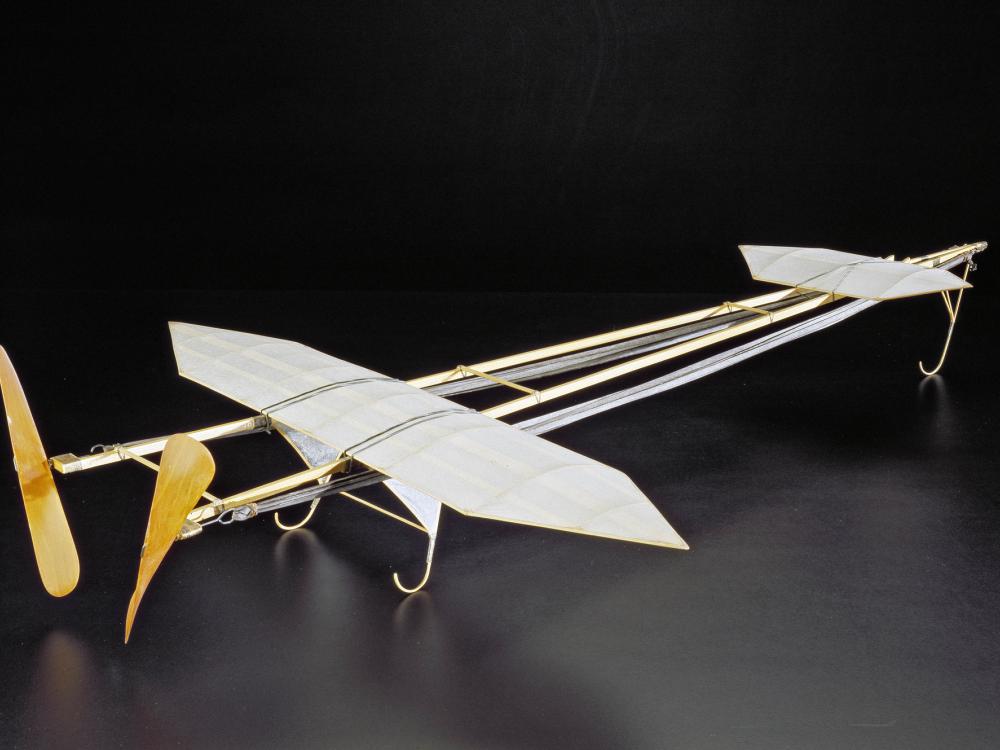 Gliding racing plane model with two separate sets of wings and rubber bands to power the plane.