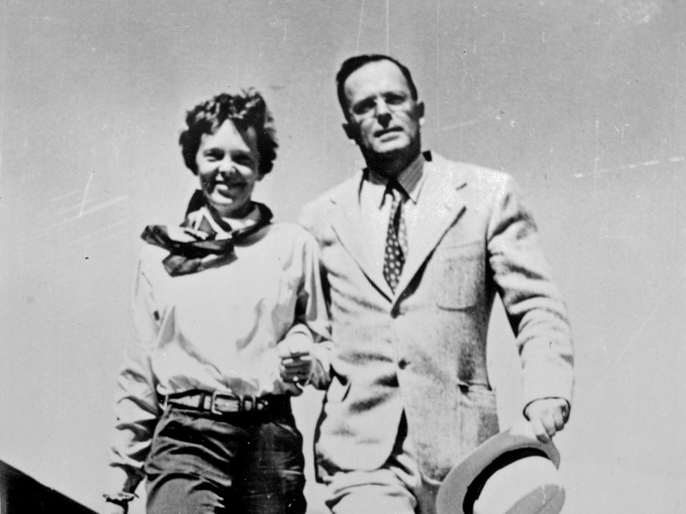 Amelia Earhart and George Palmer Putnam, a white woman and man respectively, pose informally.