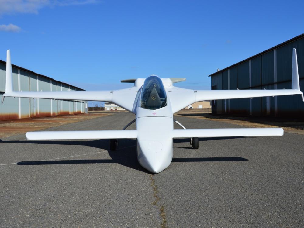 Front view of white monoplane with long tailplane and fin combo.