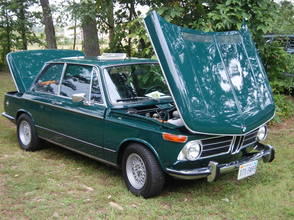 Side view of teal, four-door sedan automobile.