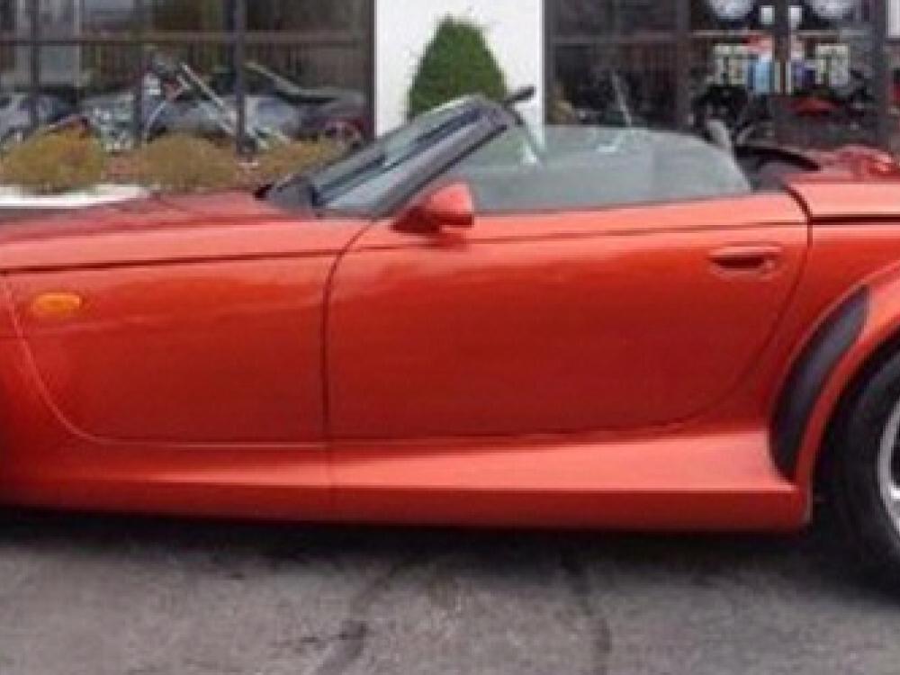 Side view of red, two-seat convertible automobile.