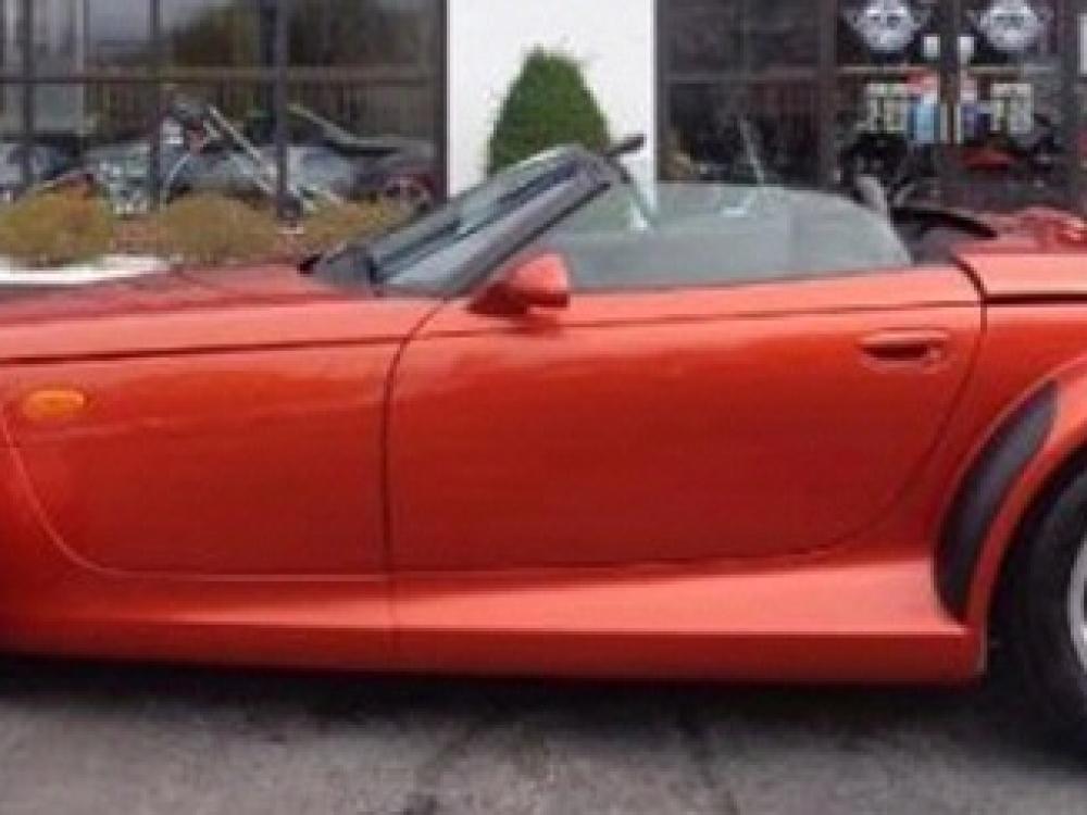 Side view of red, two-seat convertible automobile.