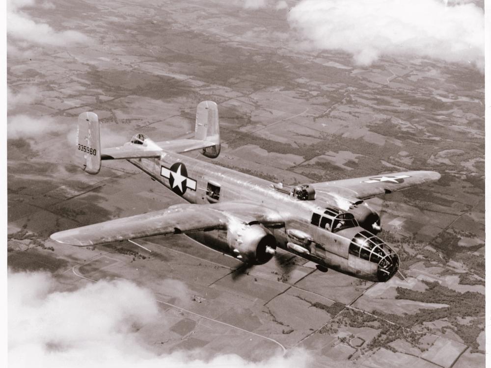 A bomber monoplane with twin engines in flight. Painting of a star near the rear of the fuselage indicates its status as a military monoplane.