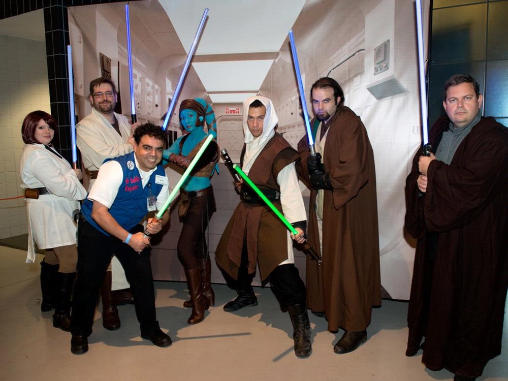 A Museum volunteer poses with people dressed in Star Wars costumes at the Museum's annual Halloween event.