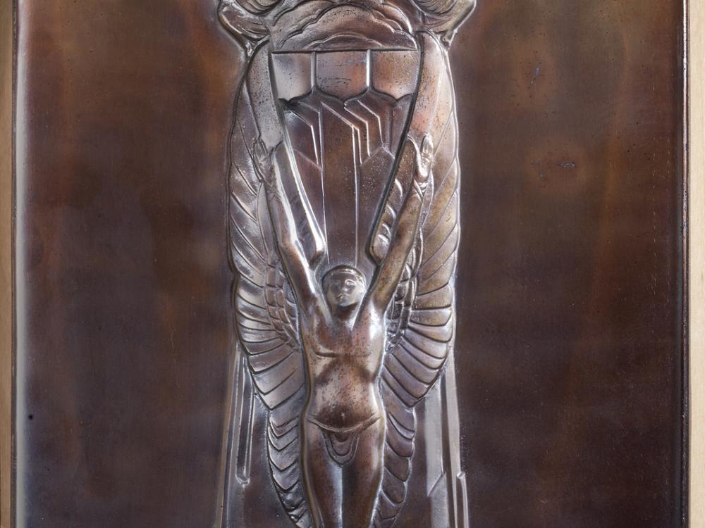 Wooden plaque featuring the "Thompson Trophy Award" name above a depiction of a male angel below a sky landscape. A silver-colored metal part enscribes James H. Doolittle as the recipient of the trophy in 1932.