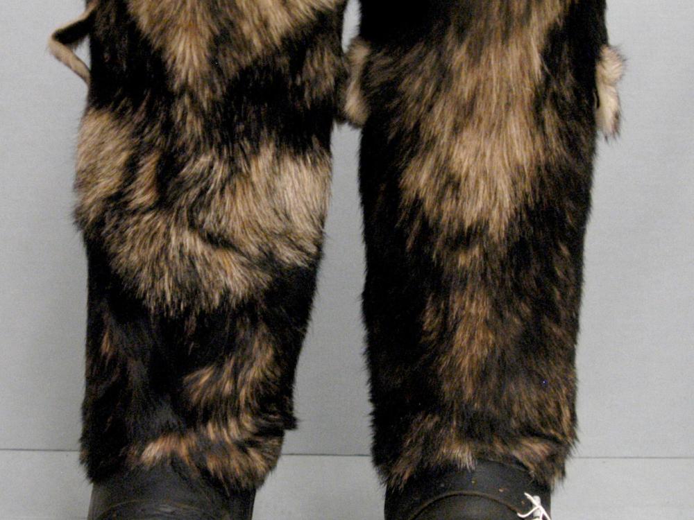 Pair of survival boots with black leather base and black and tan-brown fur on the sleeves.