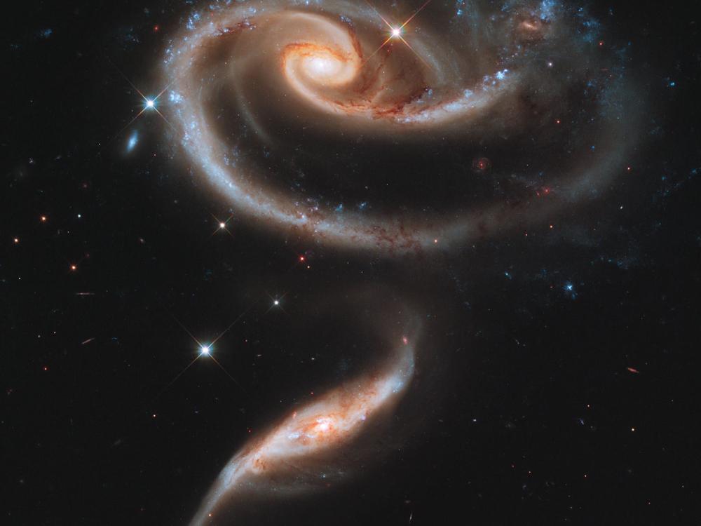 Two spiral galaxies next to each other in this image.