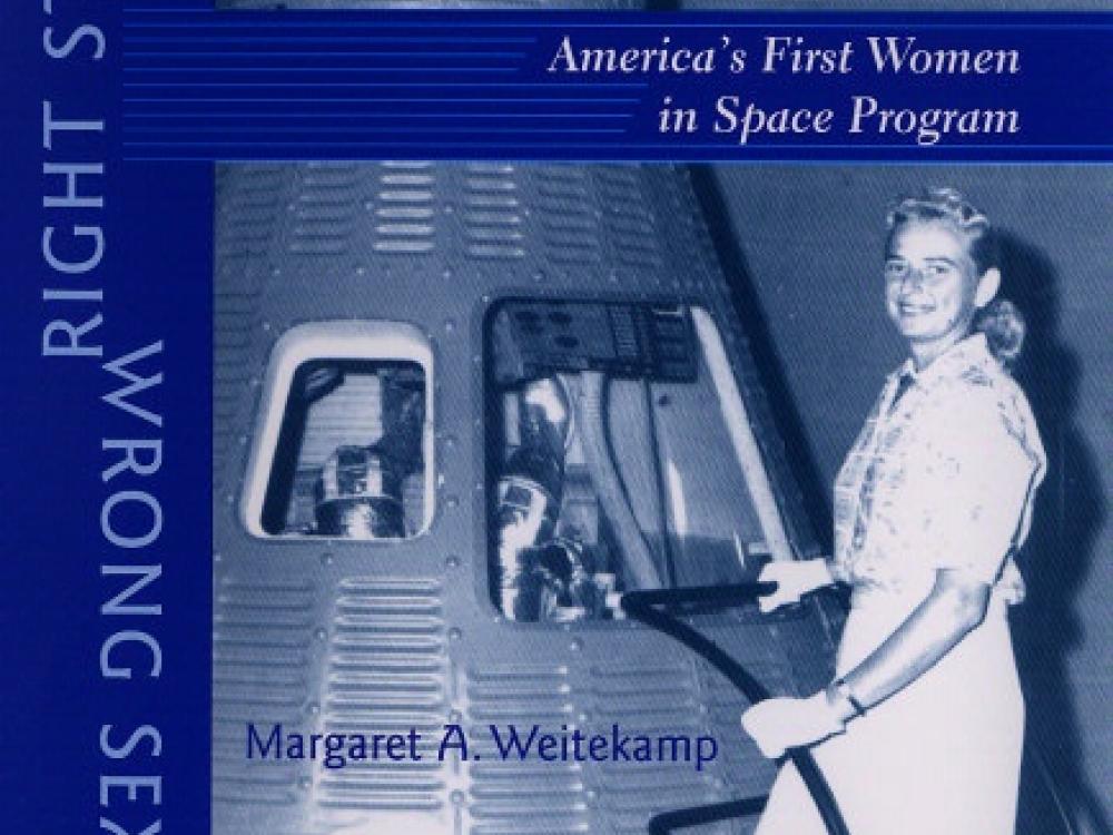 Scan of a book cover with a blue-colored photo of a female astronaut candidate standing beside a Mercury spacecraft.