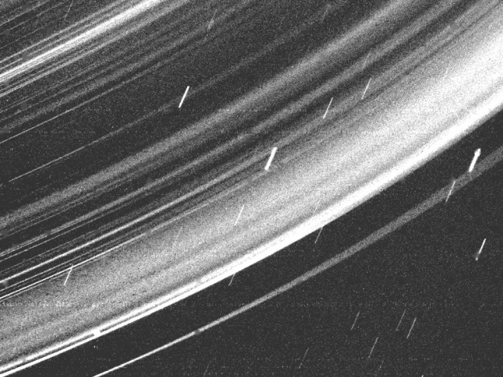 A close-up view of the ring system surrounding the core of Uranus.