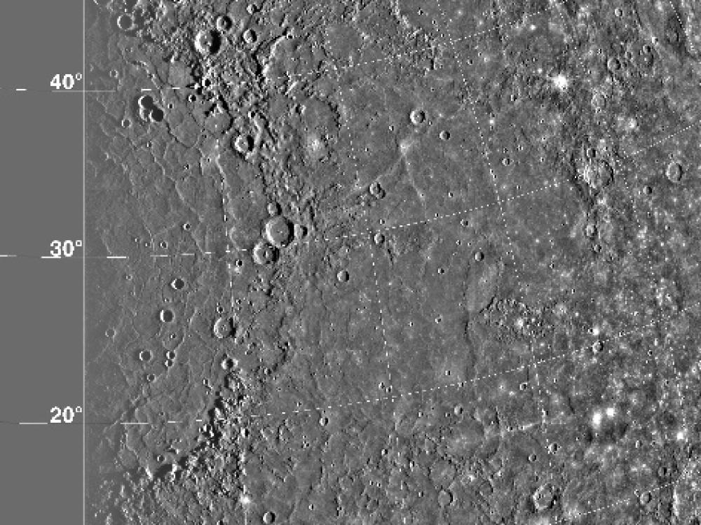 A satellite view of the Caloris Basin on Mercury. The basin features many craters of various sizes.