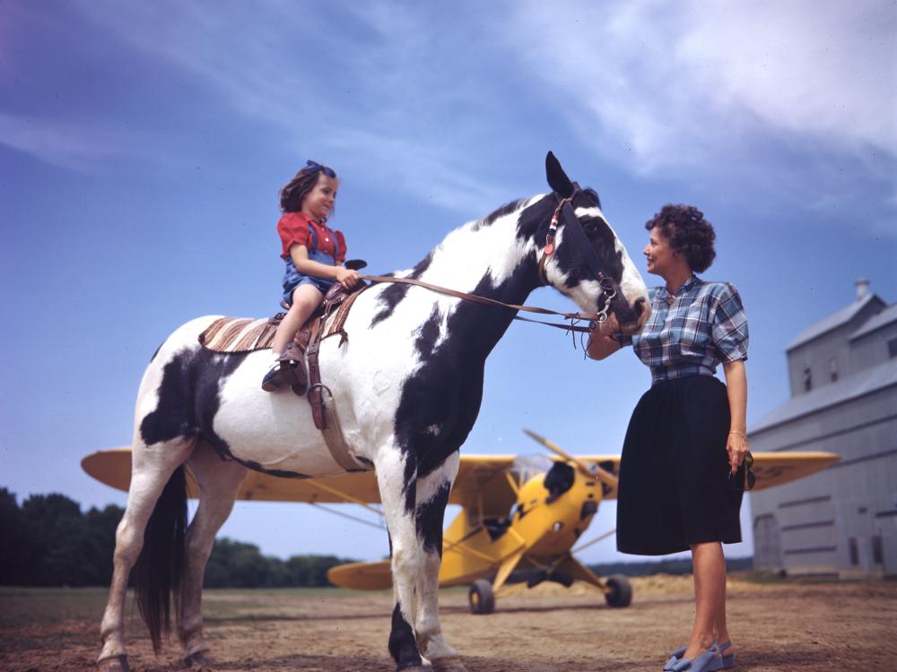 A girl, her pony, and a Piper J-3C Cub