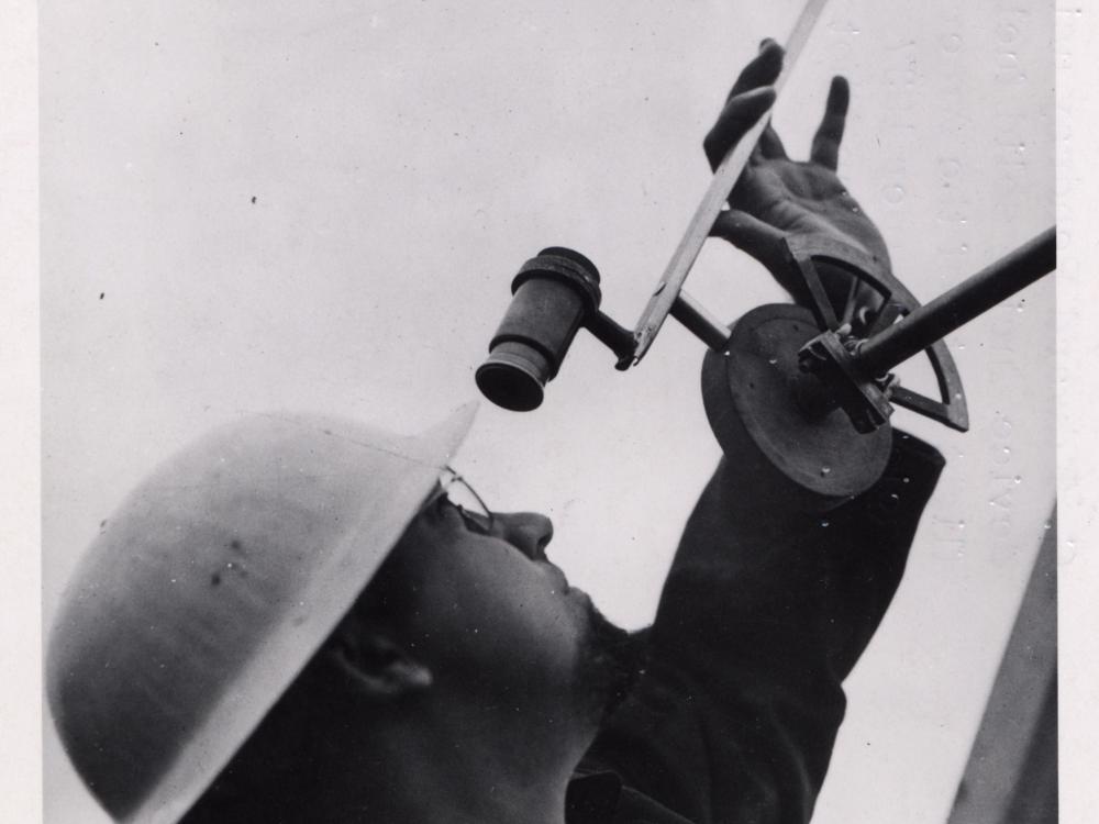 Gawain Edward “Ed” Pendray, a man, uses a tracking device to view rocket flight tests.