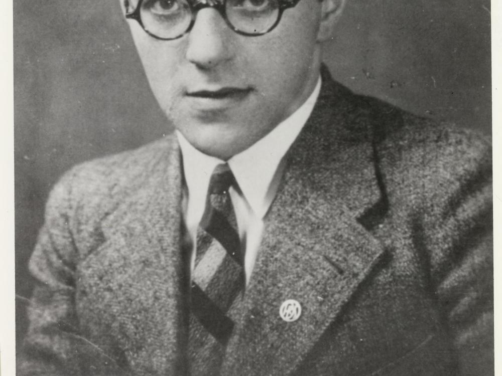 Willy Ley, a white man, poses for a portrait. He is wearing glasses and a suit.